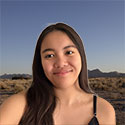 smiling girl with long black hair and black top